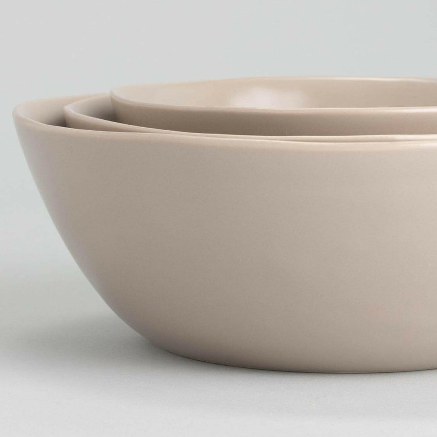 Nested serving bowls designed for space-saving storage, perfect for efficient kitchen organization and elegant table settings.