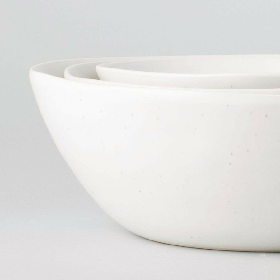 Nested serving bowls designed for space-saving storage, perfect for efficient kitchen organization and elegant table settings.