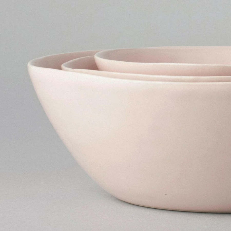 Nested serving bowls designed for space-saving storage, perfect for efficient kitchen organization and elegant table settings.