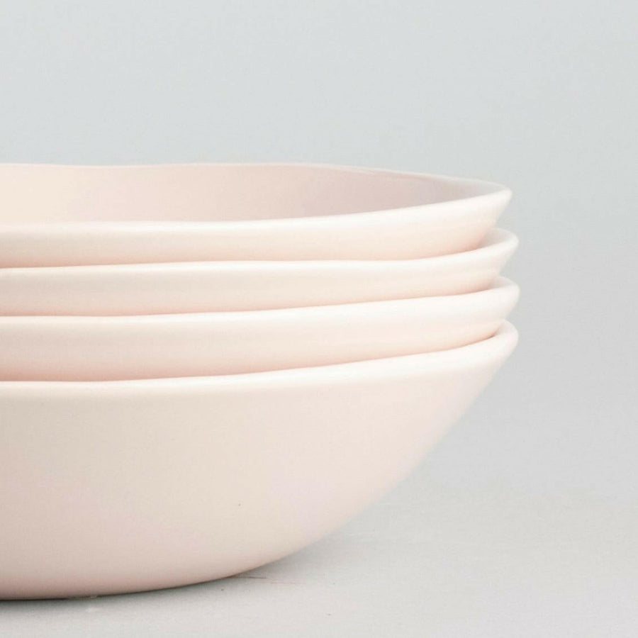 Elegant pasta bowls set on a dining table, showcasing sleek design and premium quality for sophisticated meals.