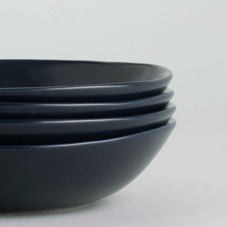 Elegant pasta bowls set on a dining table, showcasing sleek design and premium quality for sophisticated meals.