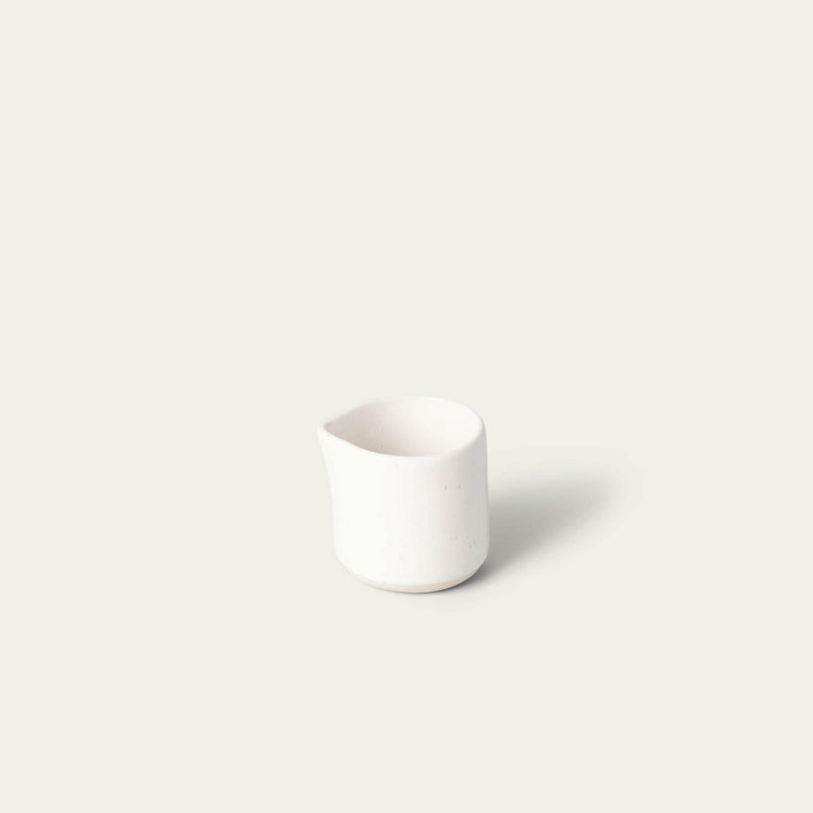 Elegant glass carafe pouring water gracefully, perfect for formal dining settings and enhancing table presentation.